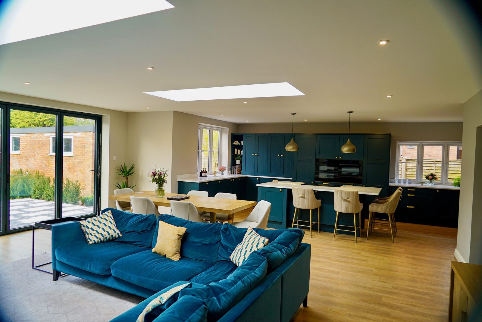 Open plan kitchen, dining and living space with roof lantern and bifold doors