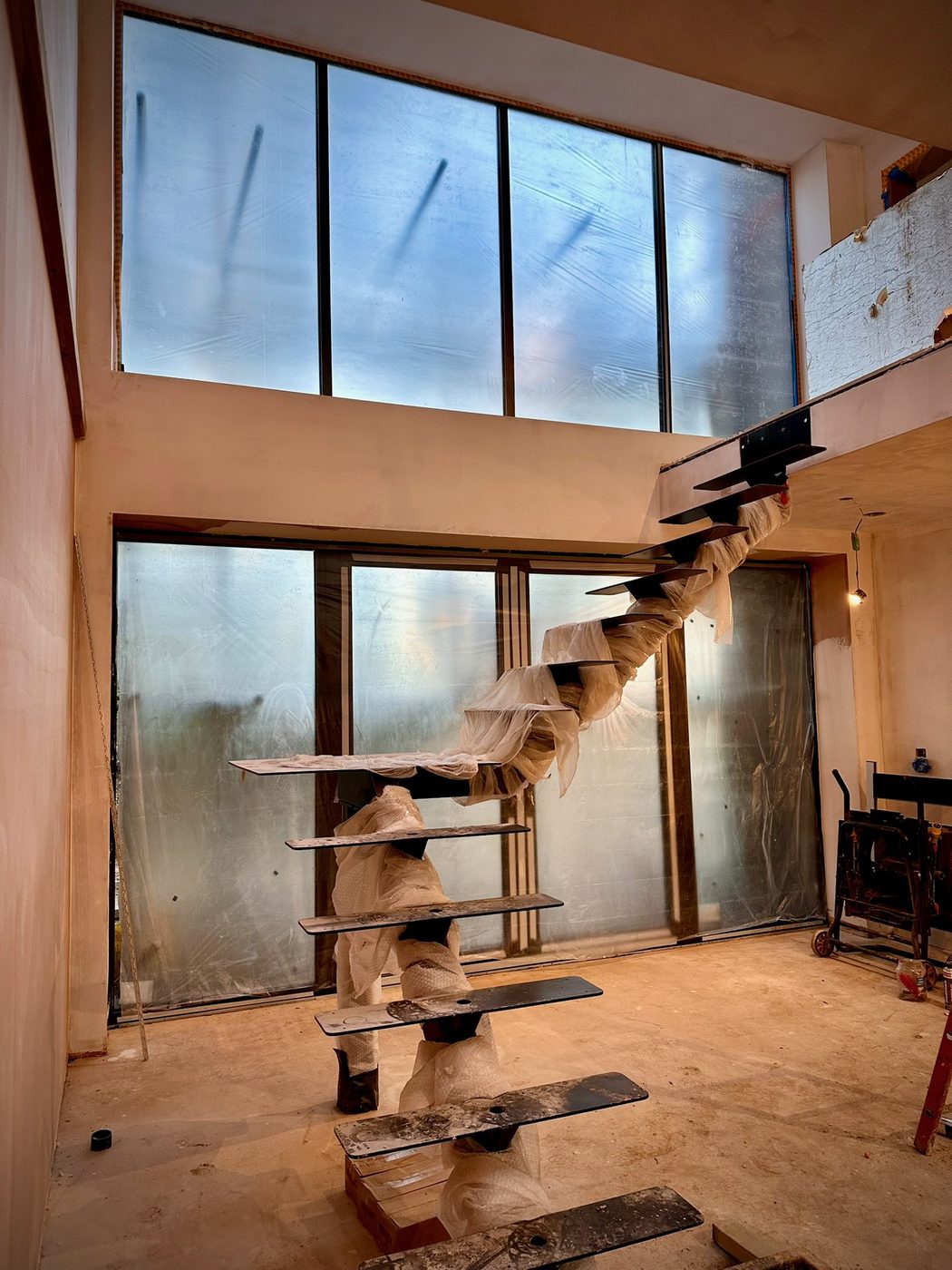 Feature staircase and full-height glazing during an internal fit out