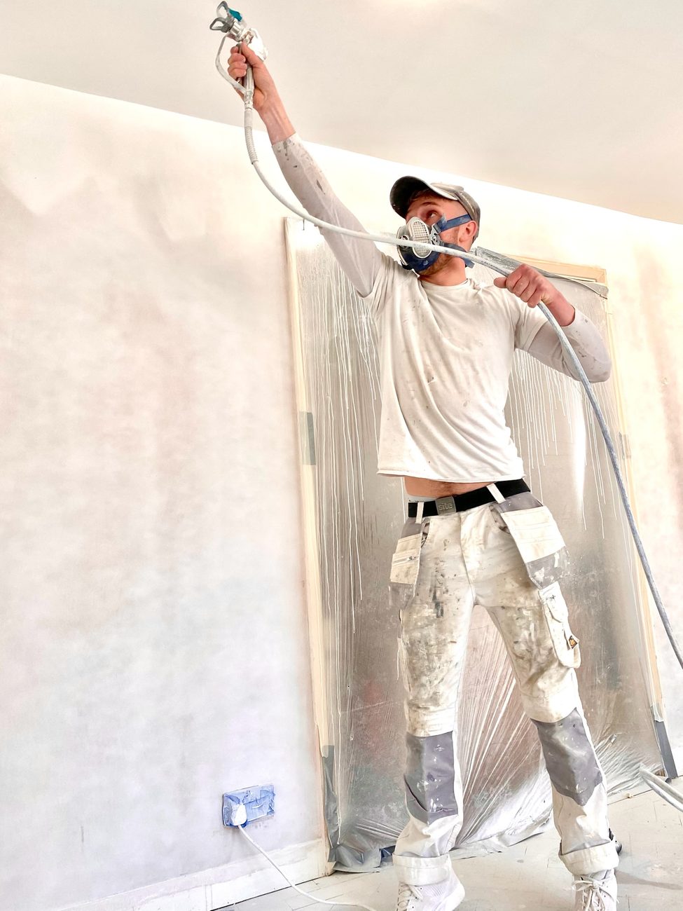Plasterer applying a skim finish to a new wall