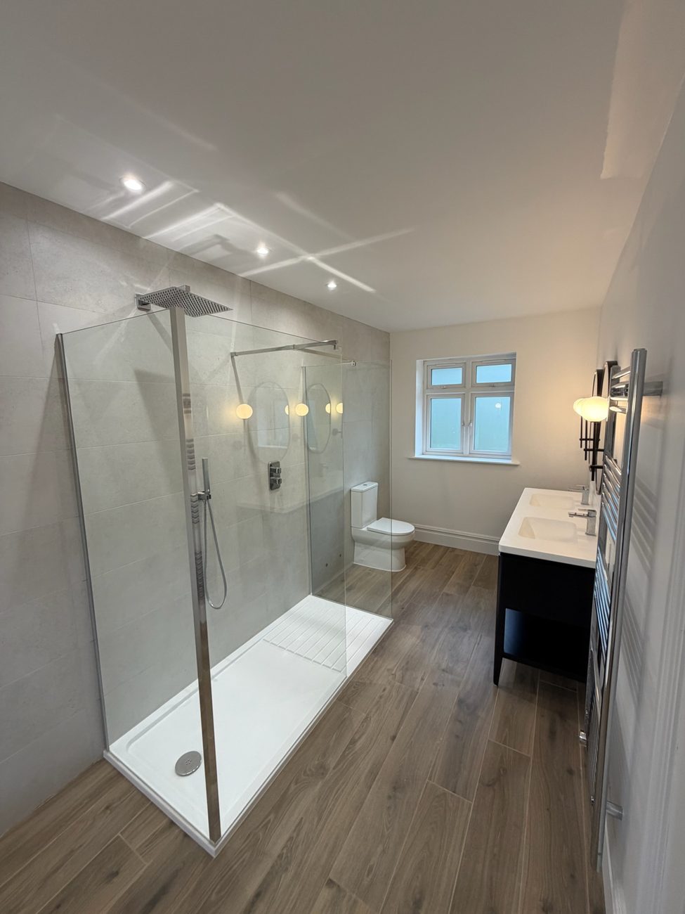 En-suite shower room with a frameless glass screen