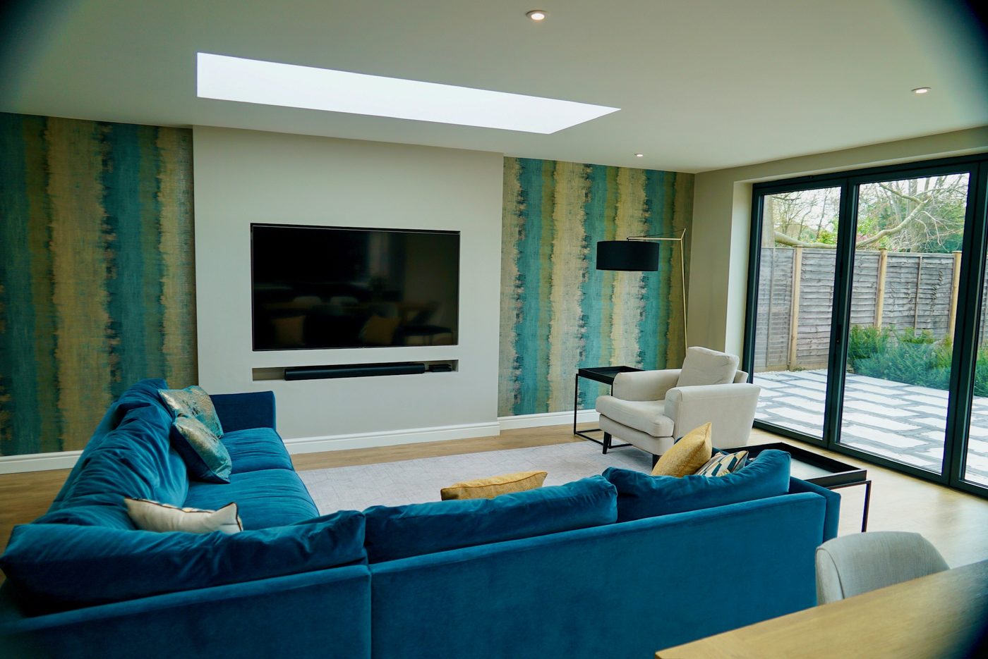 Living area of an open plan rear extension with wall-mounted television