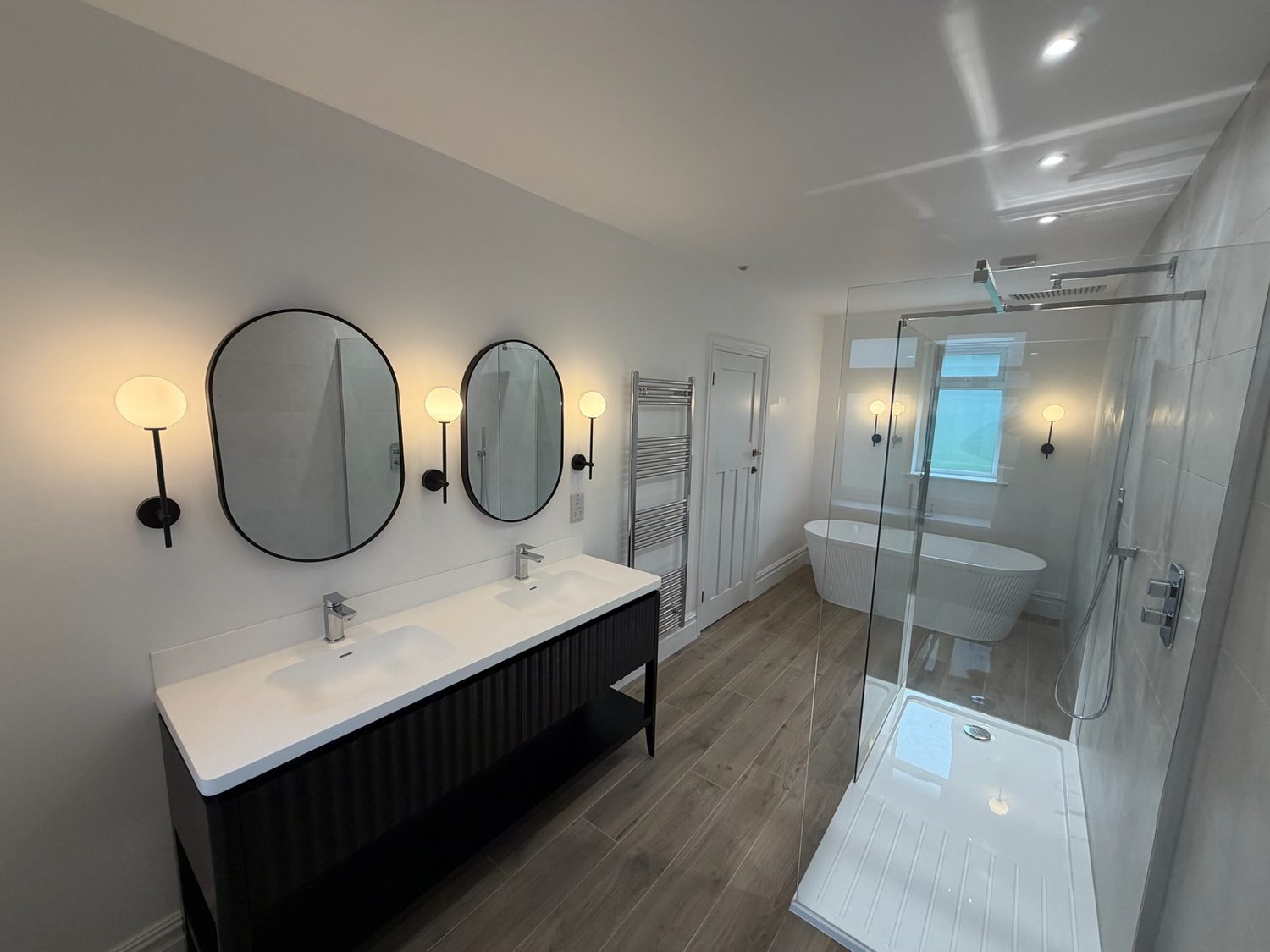 Family bathroom with twin basins, freestanding bath and walk-in shower