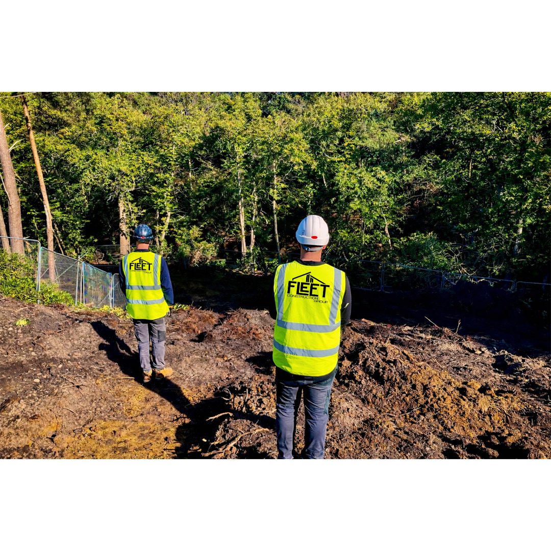 Team setting out foundations on a wooded plot