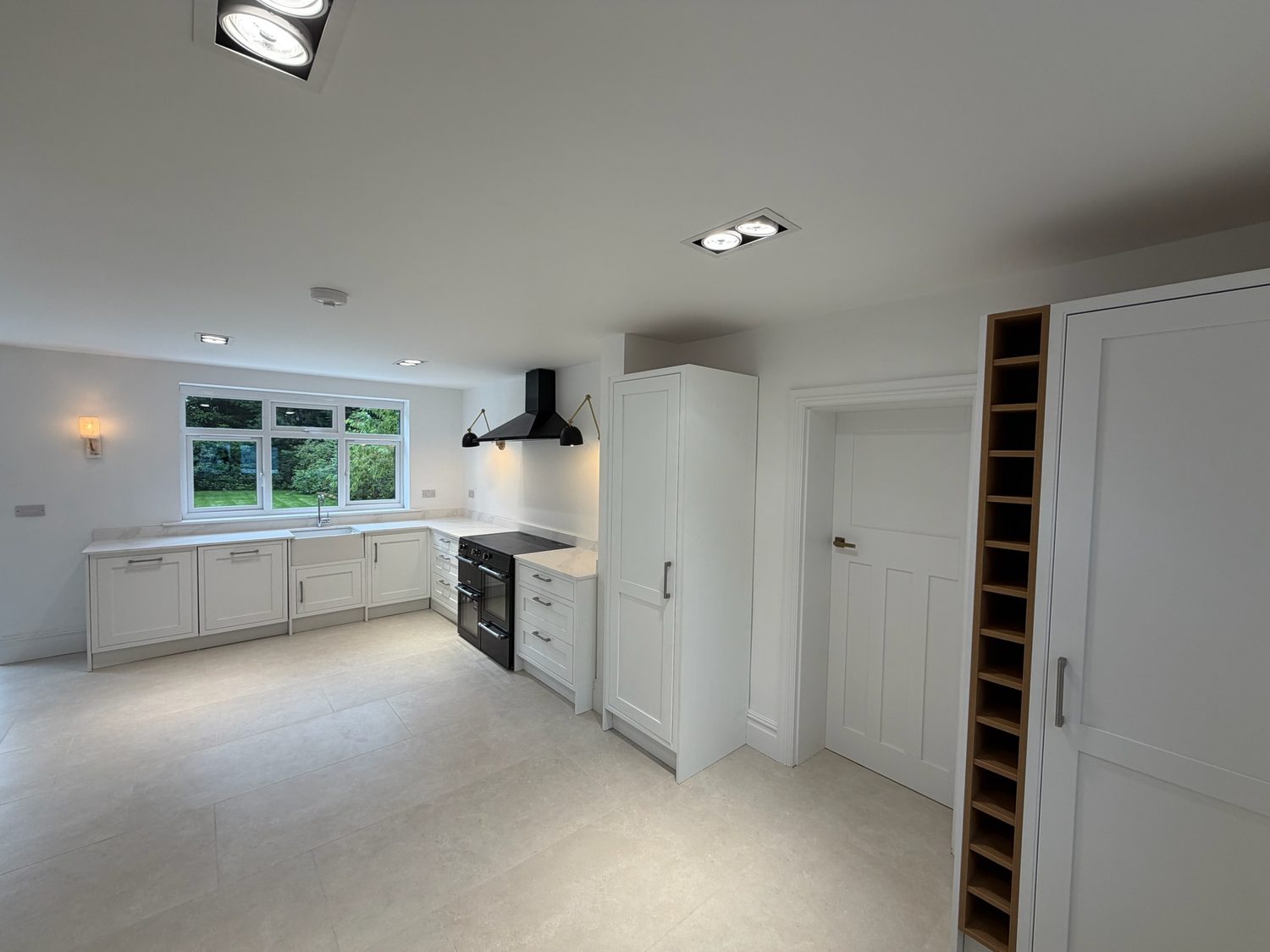 Handleless white kitchen with a range cooker in a new build home