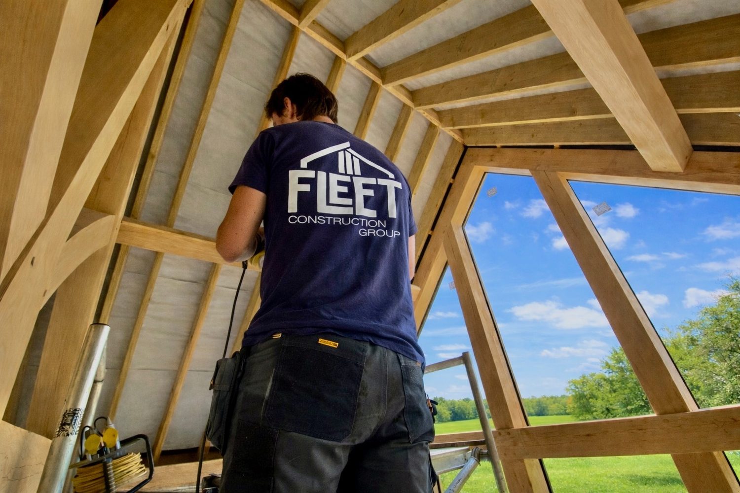 Carpenter fitting an oak framed garden room roof