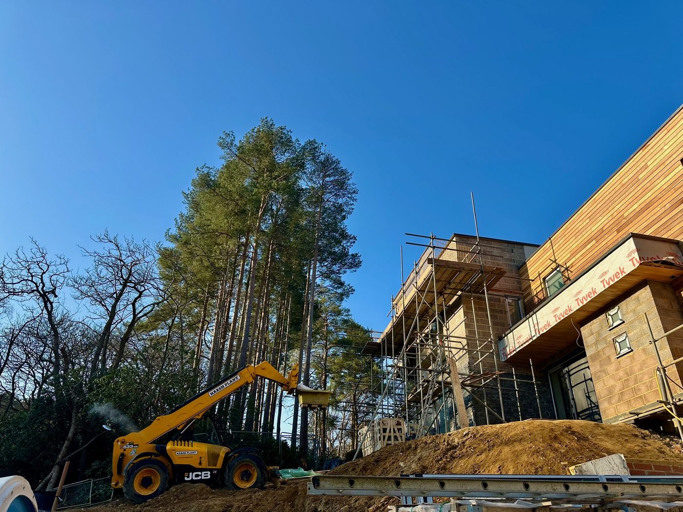 New build under construction with telehandler on site