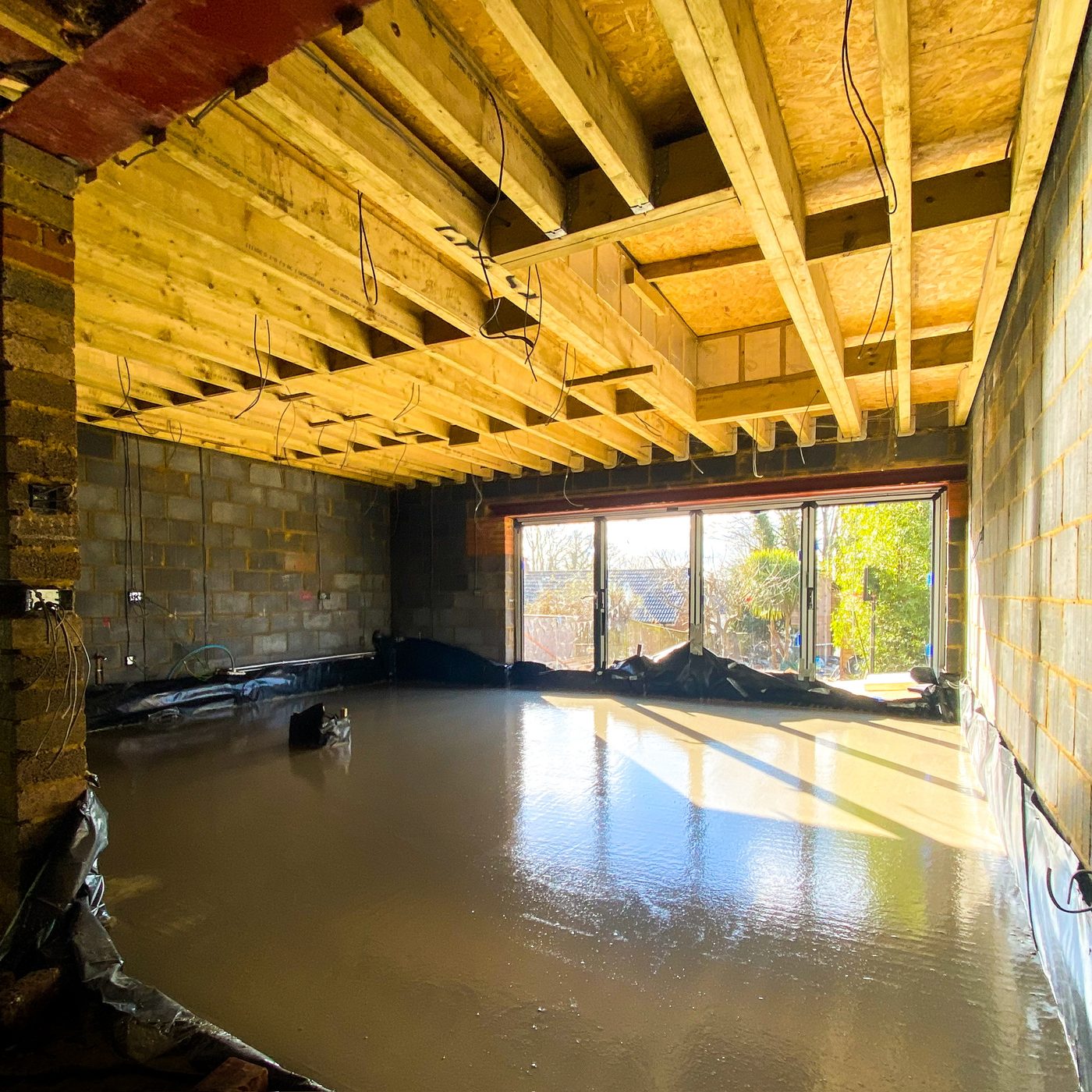 Freshly poured and levelled floor slab inside a new extension