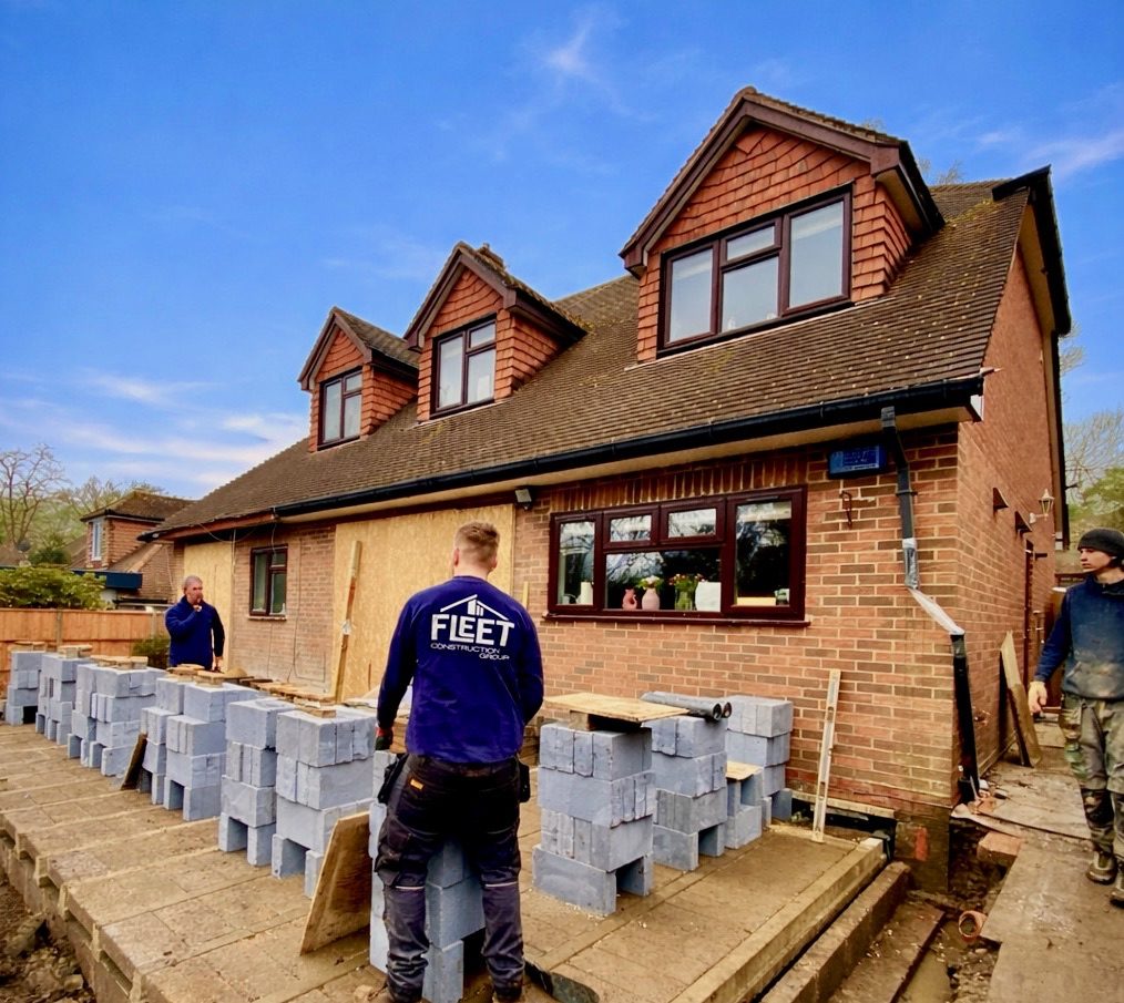 Team setting out blockwork at the front of a Fleet property